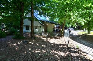 a house with a fence in front of it at Chata Zelená - Zemplínska Šírava in Vinné