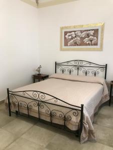 a bed in a bedroom with a picture on the wall at Le Tenute di Agnese in Felline