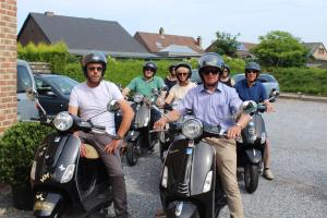 un gruppo di persone su scooter in un parcheggio di B&B De Vroling a Wellen