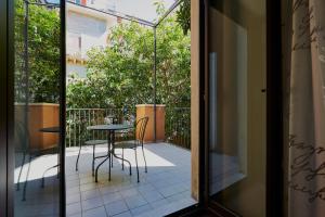 a patio with a table and chairs on a balcony at Corte dei medici - Palace in Catania