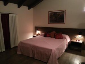 a bedroom with a large bed and two night stands at Hotel La Vecchia Reggio in Reggio Emilia