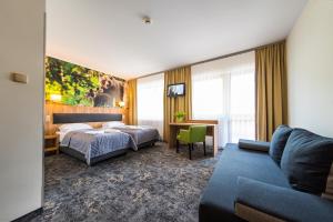 Ένα ή περισσότερα κρεβάτια σε δωμάτιο στο Góral Spa&Wellness