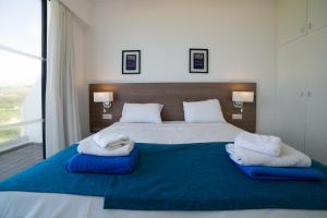A bed or beds in a room at Marica's Boutique Hotel