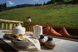 a table with a bowl of food and a bird on it at Bauerndörfl Hüttschlag in Hüttschlag