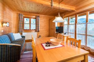 a living room with a wooden table and a couch at Bauerndörfl Hüttschlag in Hüttschlag