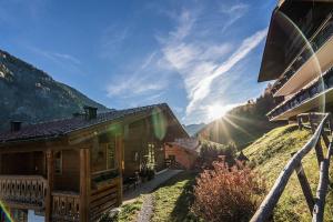 a log cabin in the mountains with the sun shining at Bauerndörfl Hüttschlag in Hüttschlag
