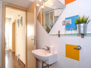a bathroom with a sink and a mirror at Apartments Pavicic Tudor in Hvar