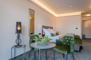 a hotel room with a bed and a table and chairs at Boutique Hotel Acacia in Lovran