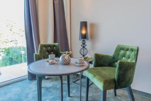 a living room with a table and two chairs at Boutique Hotel Acacia in Lovran