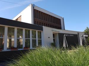 an office building with a black and white building at Doris Hotel in Siófok