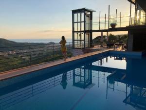 a woman standing next to a swimming pool at Chincamea in Casarza Ligure