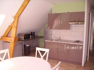 a small kitchen with a sink and a microwave at La Grimodière Gîte in Ranville