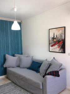 um sofá numa sala de estar com um quadro na parede em Comfort in the Downtown em Porto