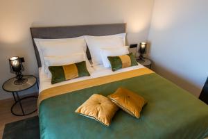 a bedroom with a large bed with pillows at Boutique Hotel Acacia in Lovran