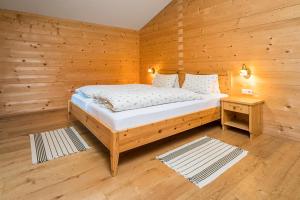 a bedroom with a bed in a wooden room at Bauerndörfl Hüttschlag in Hüttschlag