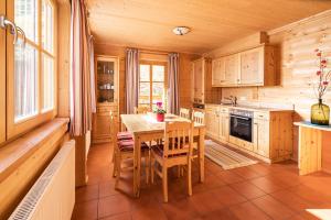 a kitchen with a table and chairs in a cabin at Bauerndörfl Hüttschlag in Hüttschlag