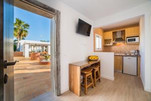a kitchen with an open door to a patio at Villa Can Raes in Sant Rafael
