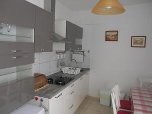 a kitchen with a sink and a stove top oven at Hvar apartment in Hvar +15 photos