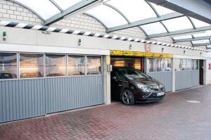 a car is parked inside of a garage at LIHO - einfach Lübeck in Lübeck