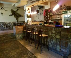 a bar with a bunch of stools in a restaurant at Apartment Suzana in Mavrovo