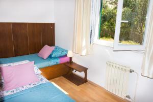 a small room with a bed and a window at Holiday Home Laurea in Supetar
