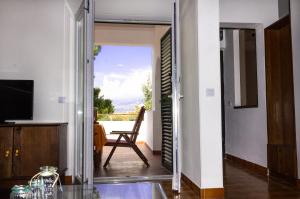 a living room with a sliding glass door leading to a balcony at Holiday Home Laurea in Supetar
