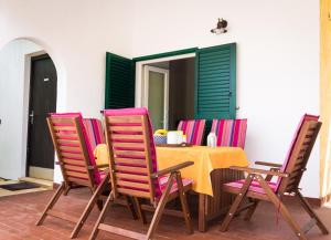 a table and four chairs with a table and a table at Holiday Home Laurea in Supetar