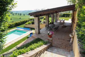 a backyard with a swimming pool and a pergola at Cerasus B&B in San Marcello