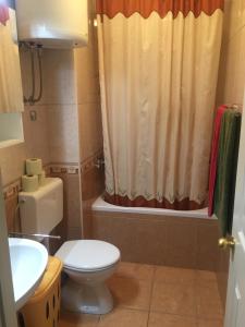 a bathroom with a toilet and a shower curtain at jakov in Podgora +21 photos