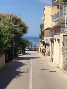 an empty street with the ocean in the background at jakov in Podgora