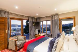 a bedroom with a bed and a large window at Madison Manor Boutique Hotel in Knysna