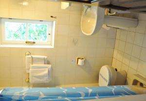 a bathroom with a toilet and a window at Margarita Hotel in Kythira