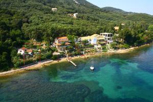 an aerial view of a beach with a boat in the water at Studio Nausica... a sense of paradise! in Agia Pelagia Chlomou