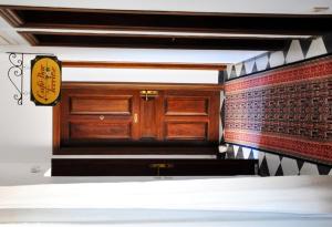 a room with a bed and wooden cabinets and a wall at Margarita Hotel in Kythira