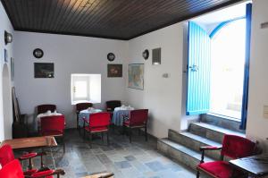 a dining room with tables and chairs and a window at Margarita Hotel in Kythira