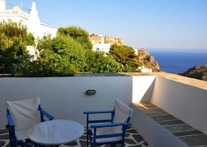 two chairs and a table on a balcony with the ocean at Margarita Hotel in Kythira