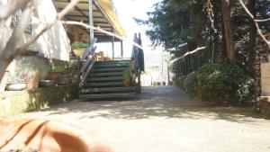 a stairway leading to a building with potted plants at Kisik Konagi in Küçükkuyu