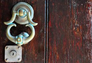 a metal door knocker on a wooden door at Margarita Hotel in Kythira