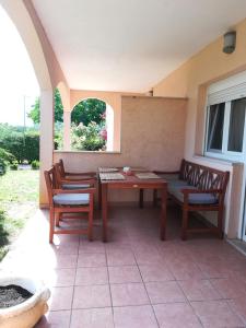 a patio with a table and chairs on a patio at Apartment Tanja in Vrsar