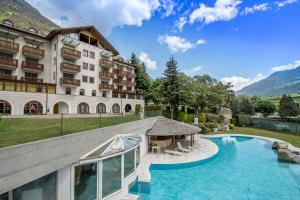 an image of a hotel with a swimming pool at Hotel Vermoi in Laces