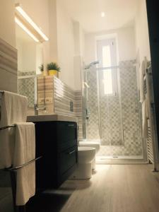 a bathroom with a sink and a toilet and a window at Queen Chic Apartment in La Spezia
