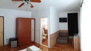 uma sala de estar com uma ventoinha de tecto e um quarto em Bed & Breakfast Batosic Makarska em Makarska