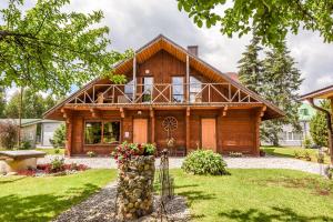 a log home with a gambrel roof at Rasos sodyba in Prienai