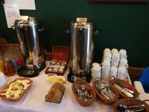 a table topped with two blenders and baskets of food at Dom Wczasowy Ventus in Łeba