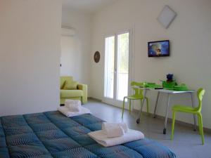 a bedroom with a bed and a table with chairs at Iride Guest House in Oristano