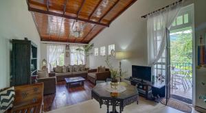a living room with a couch and a table at Hanthana Villa in Kandy