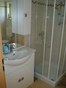 a bathroom with a sink and a shower at Apartment studio TA-TI in Umag
