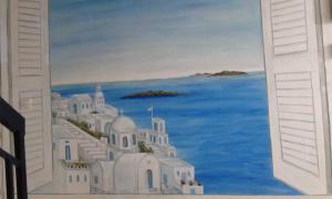 een schilderij van een eiland met witte gebouwen en de oceaan bij Retro Rooms in Loutra Edipsou