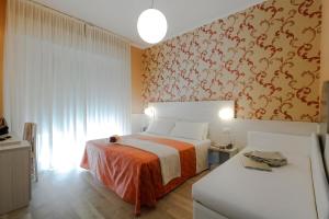A bed or beds in a room at Hotel Ombretta Mare