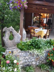 a garden in front of a restaurant with flowers at Dionysus Lasithi Plateau in Magoulás